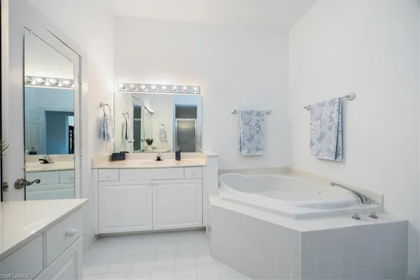 a bathroom with a bathtub sink and mirror