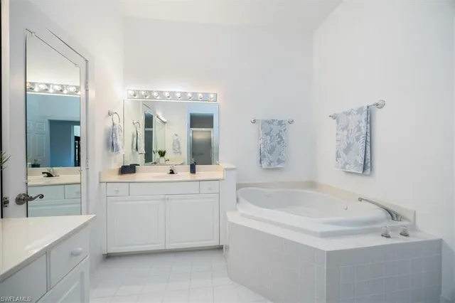 a bathroom with a bathtub sink and mirror