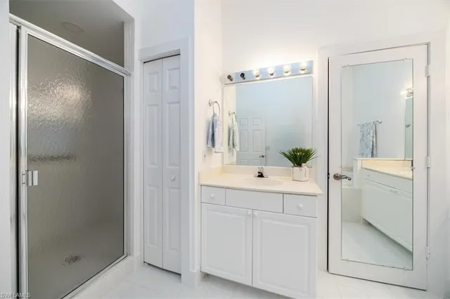 a bathroom with a shower and a sink