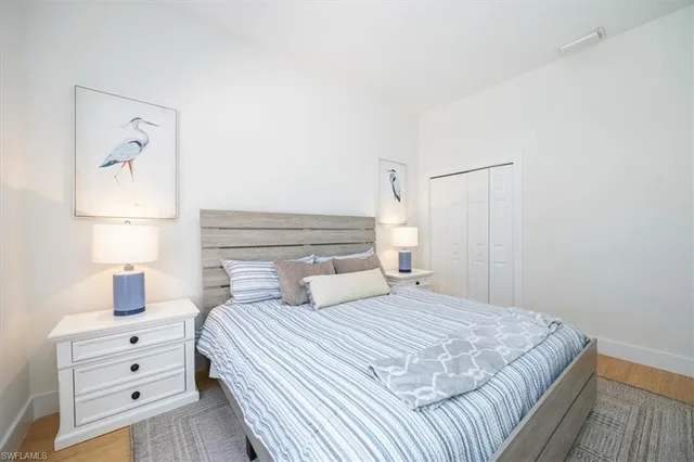 a bedroom with a bed and a night stand