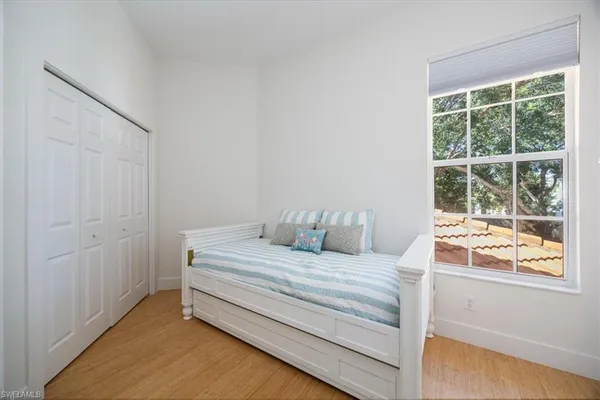 a bedroom with a bed and a window