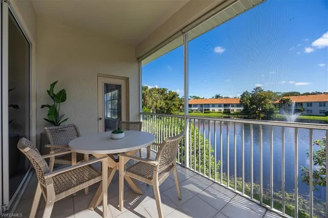 a view of a balcony with furniture and wooden floor