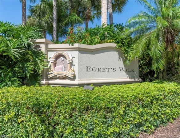 a sign that is sitting in front of flowers