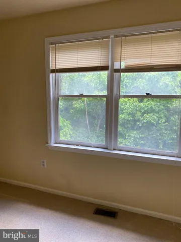 a view of a livingroom with a ceiling fan and window