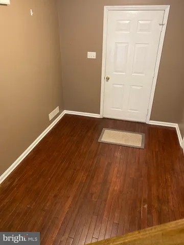 a view of an entryway with wooden floor