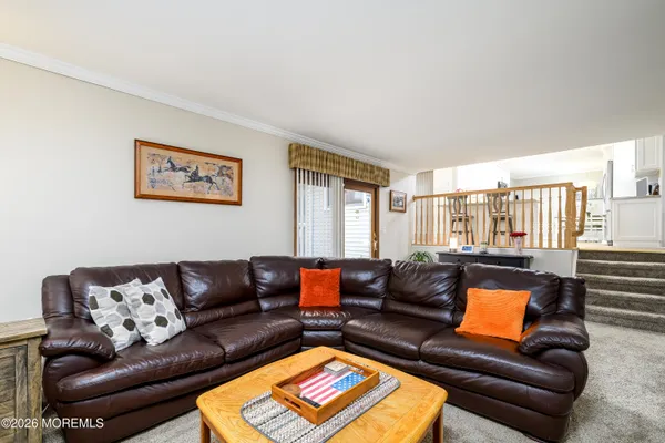 a roof deck with couches and wooden floor