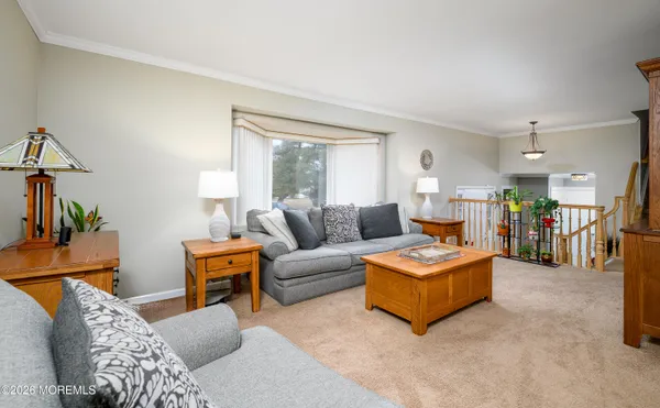 a living room with furniture a dining table and chairs