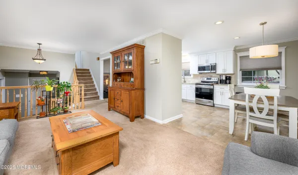 a kitchen with a dining table cabinets and stainless steel appliances