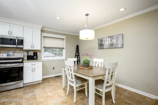 a view of a dining room with furniture and window