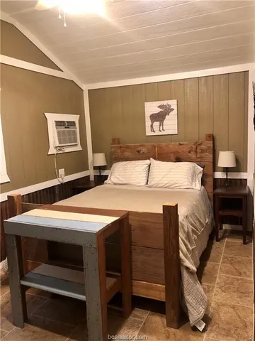 a bedroom with a bed and a dresser