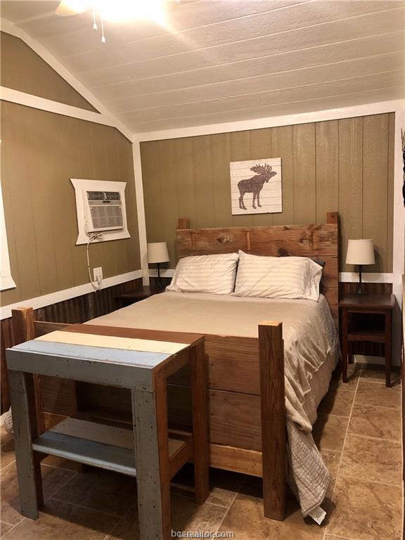 11351 Oak Lake Road Bryan, TX 77808 - Photo 12 of 20 a bedroom with a bed and a dresser