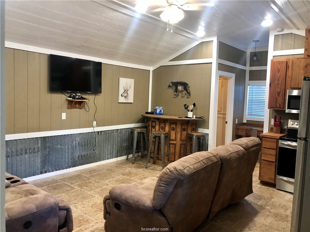11351 Oak Lake Road Bryan, TX 77808 - Photo 2 of 20 a living room with furniture and a flat screen tv