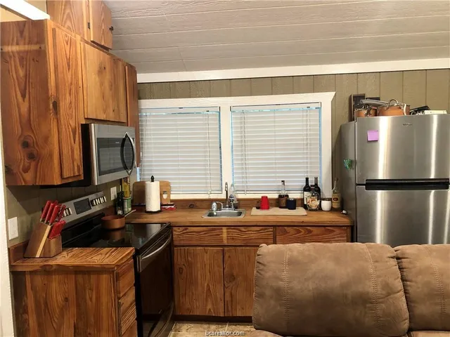 a kitchen with a refrigerator a sink and a stove