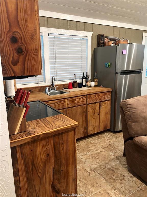 11351 Oak Lake Road Bryan, TX 77808 - Photo 8 of 20 a kitchen with stainless steel appliances granite countertop a sink refrigerator and cabinets
