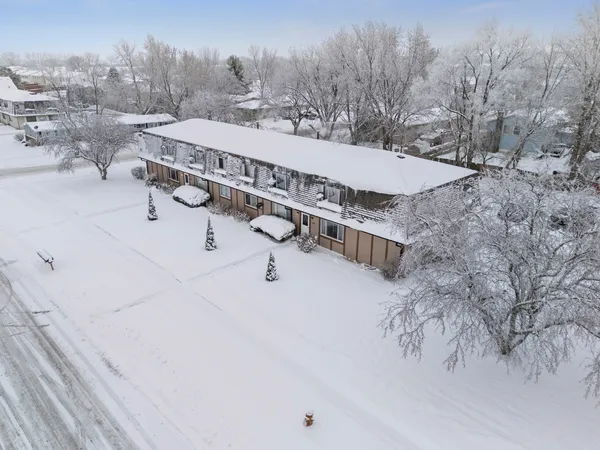 a view of a terrace with a bench and trees in the background
