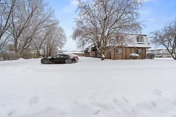 a view of large house with a yard covered in snow