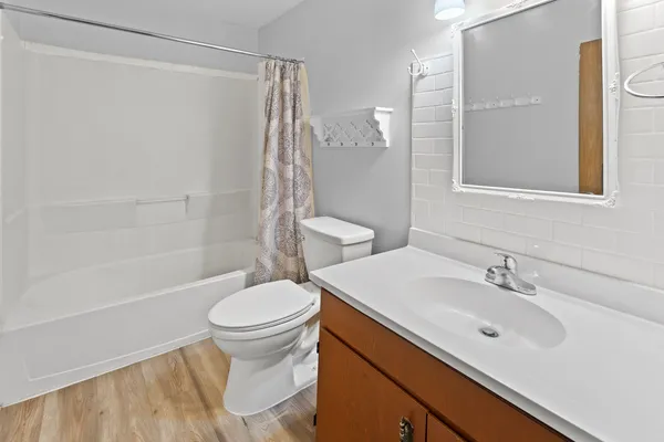 a kitchen with granite countertop a refrigerator stove top oven and sink