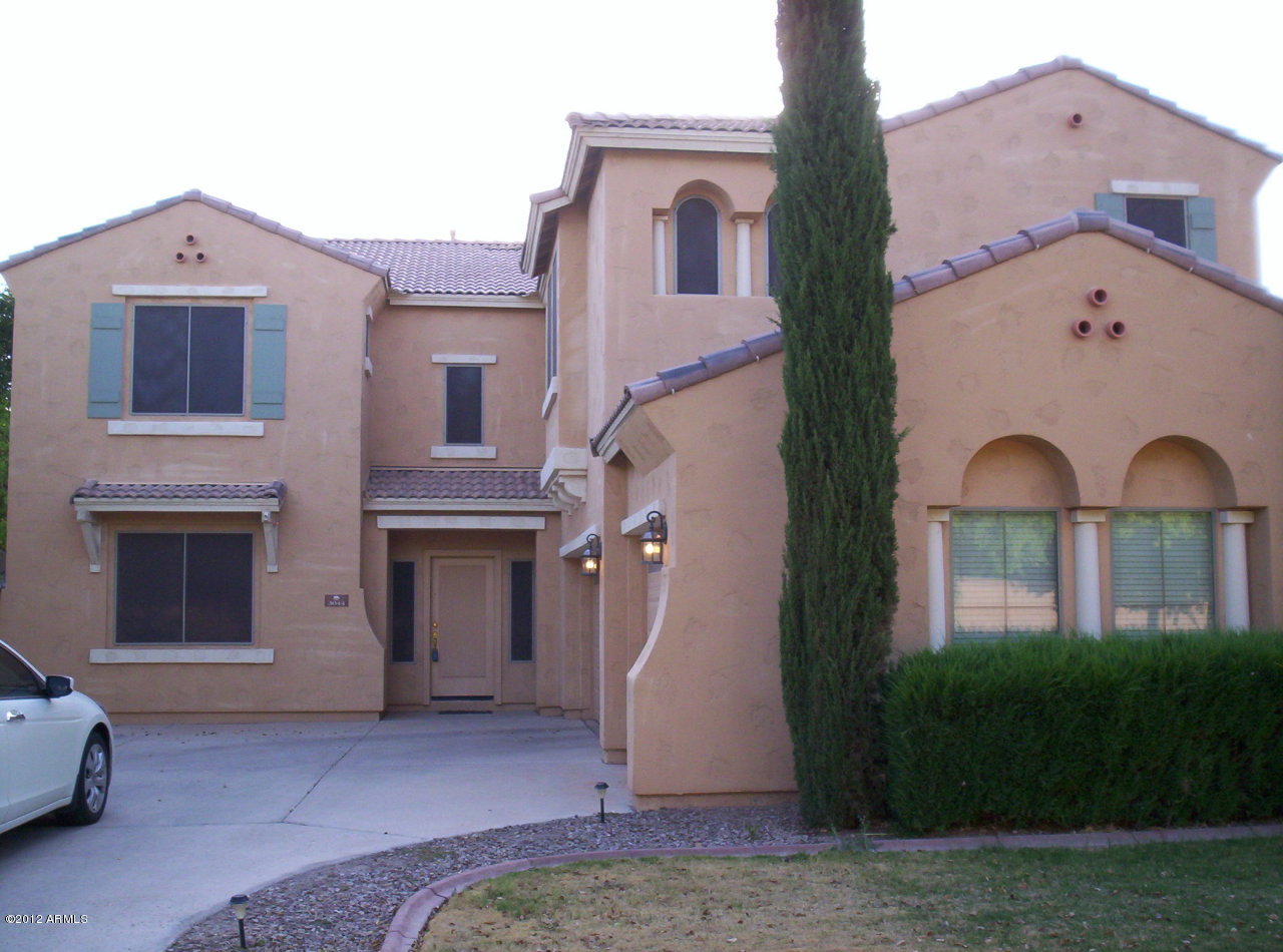 3044 South Martingale Road Gilbert, AZ 85295 - Photo 15 of 20 a front view of a house with a yard and garage