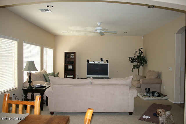 3044 South Martingale Road Gilbert, AZ 85295 - Photo 3 of 20 a living room with furniture and a flat screen tv
