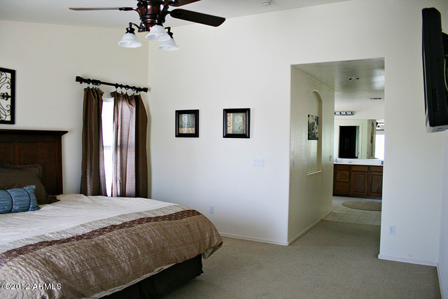 3044 South Martingale Road Gilbert, AZ 85295 - Photo 7 of 20 a bedroom with a bed and a television