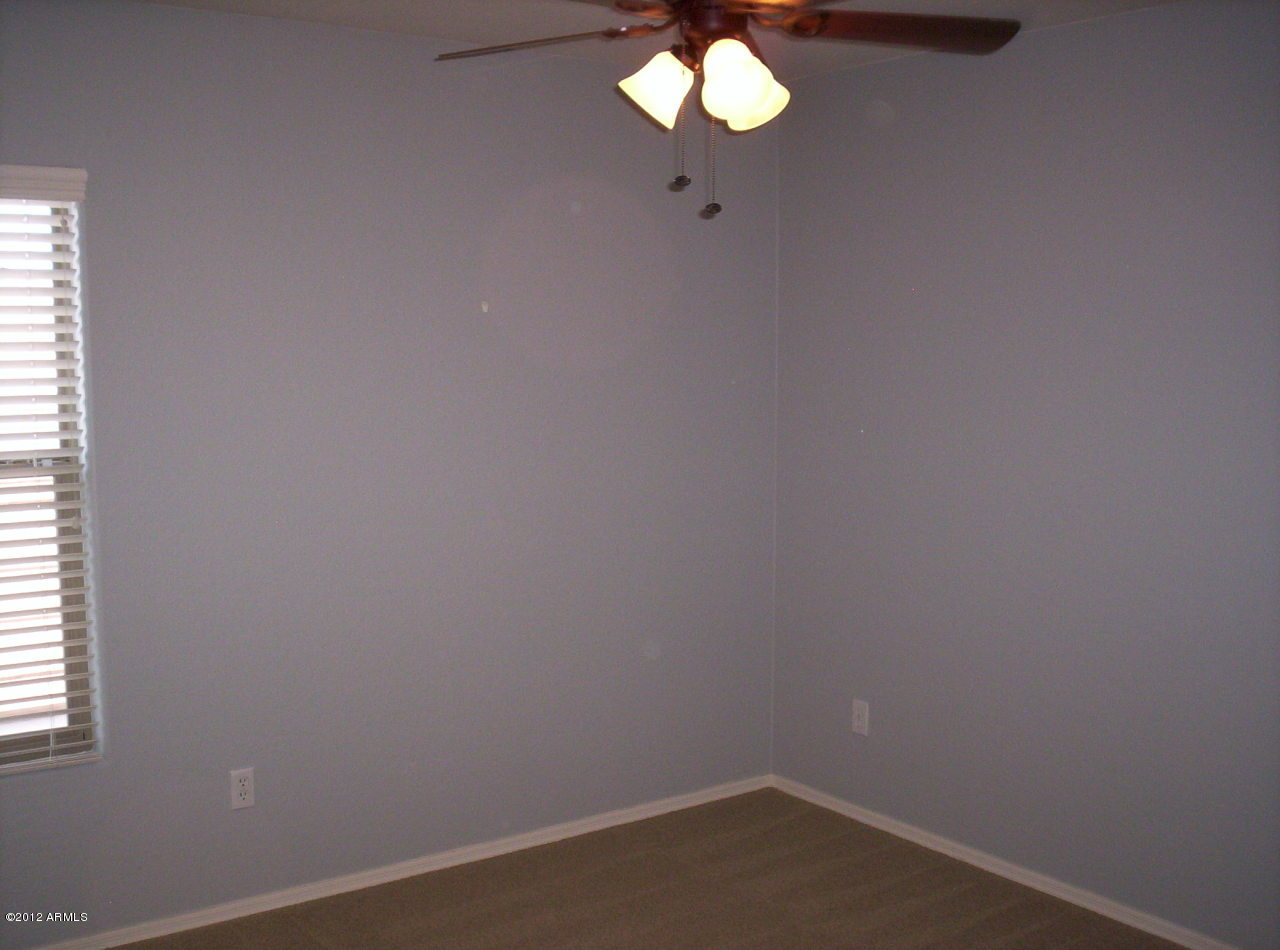 3044 South Martingale Road Gilbert, AZ 85295 - Photo 9 of 20 an empty room with a chandelier fan
