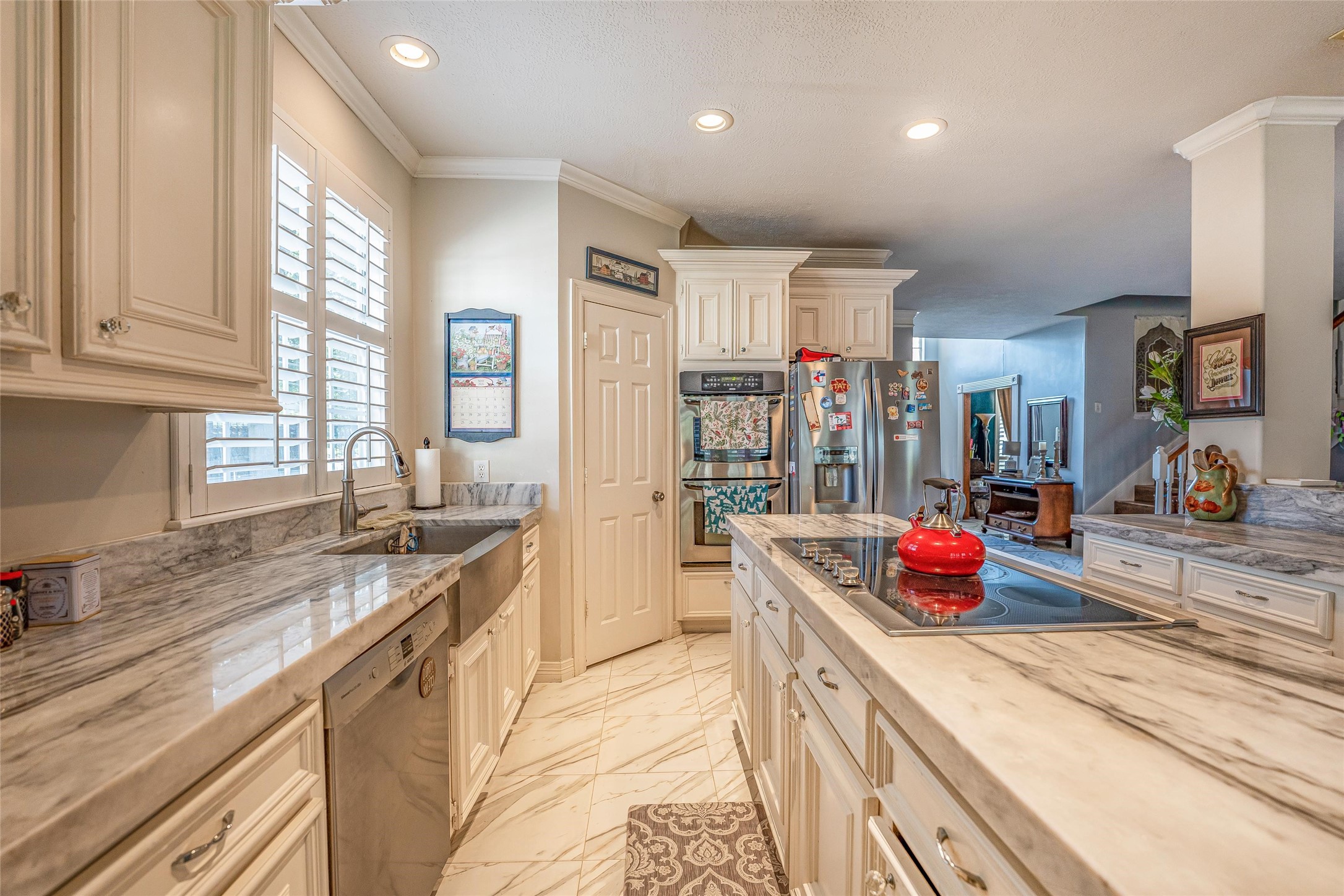 8002 Royal Crest Court Spring, TX 77379 - Photo 14 of 50 a kitchen with stainless steel appliances granite countertop a sink and cabinets