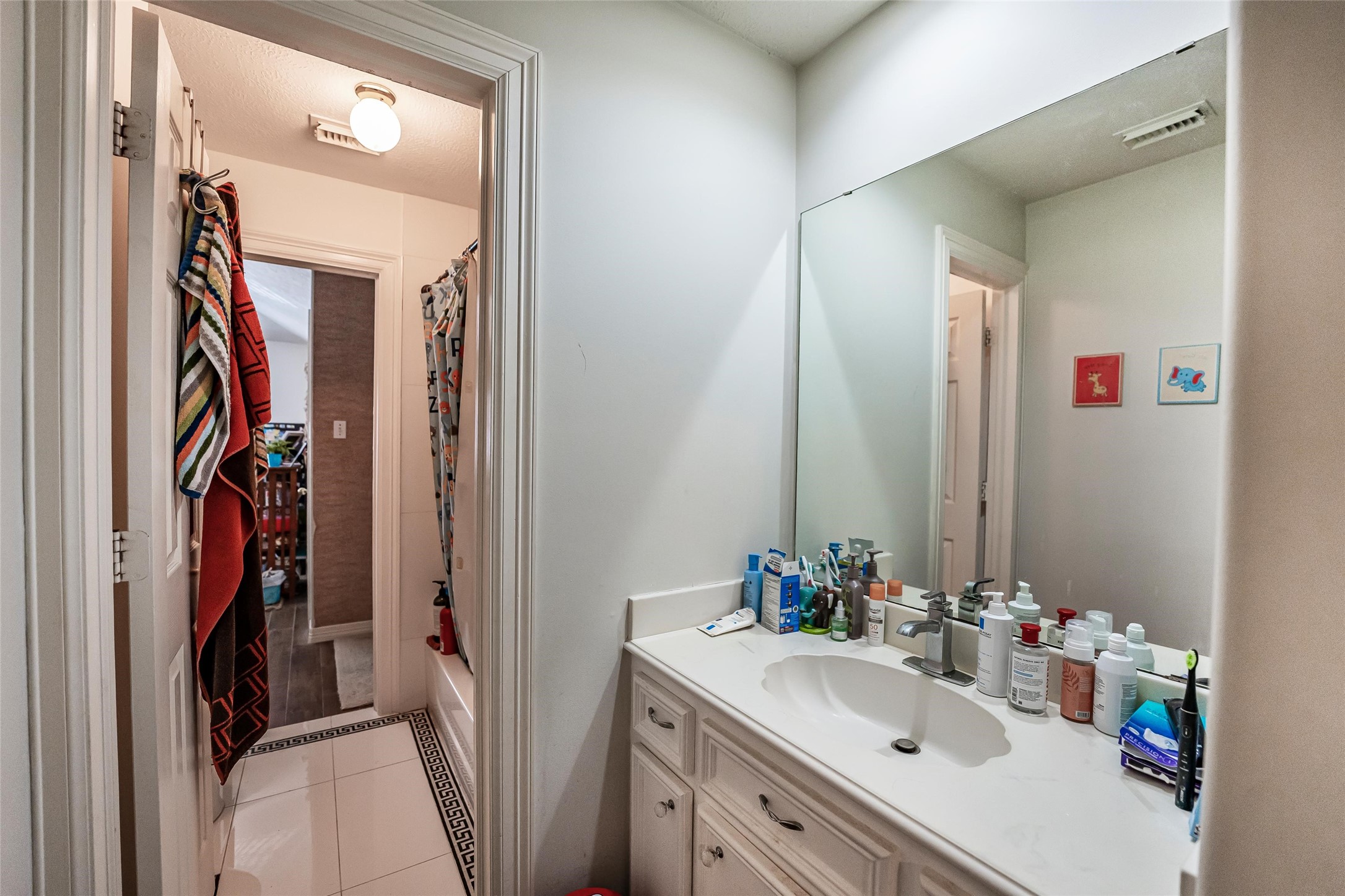 8002 Royal Crest Court Spring, TX 77379 - Photo 27 of 50 a bathroom with a sink vanity and mirror