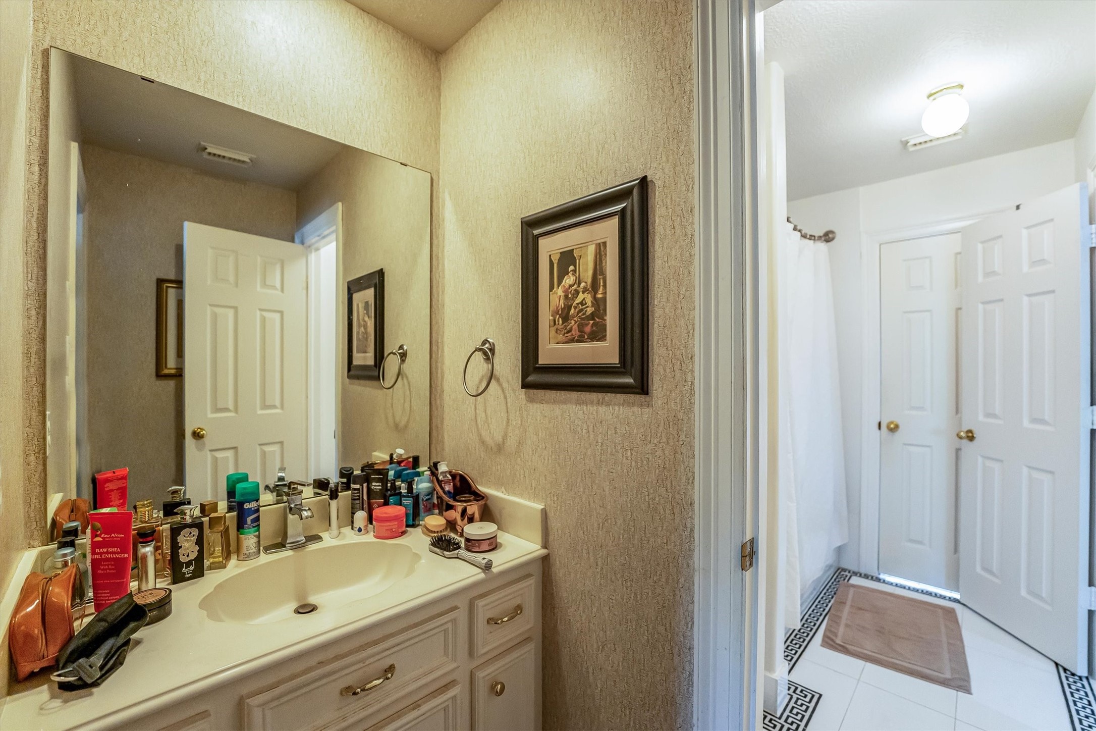 8002 Royal Crest Court Spring, TX 77379 - Photo 35 of 50 a bathroom with a double vanity sink mirror and shower