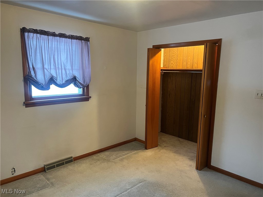 7296 Poore Road Conneaut, OH 44030 - Photo 11 of 27 Unfurnished bedroom with light colored carpet and baseboards