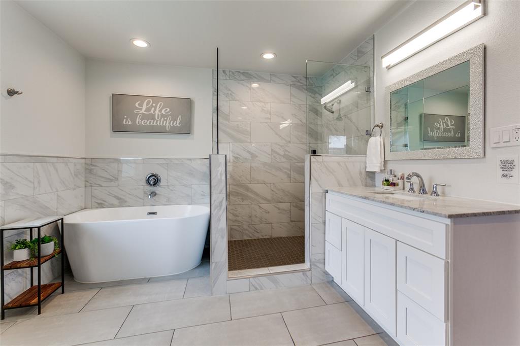 2901 Regal Road Plano, TX 75075 - Photo 15 of 23 a bathroom with a bathtub sink and mirror