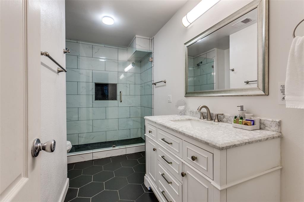 2901 Regal Road Plano, TX 75075 - Photo 18 of 21 a bathroom with a sink vanity and a mirror
