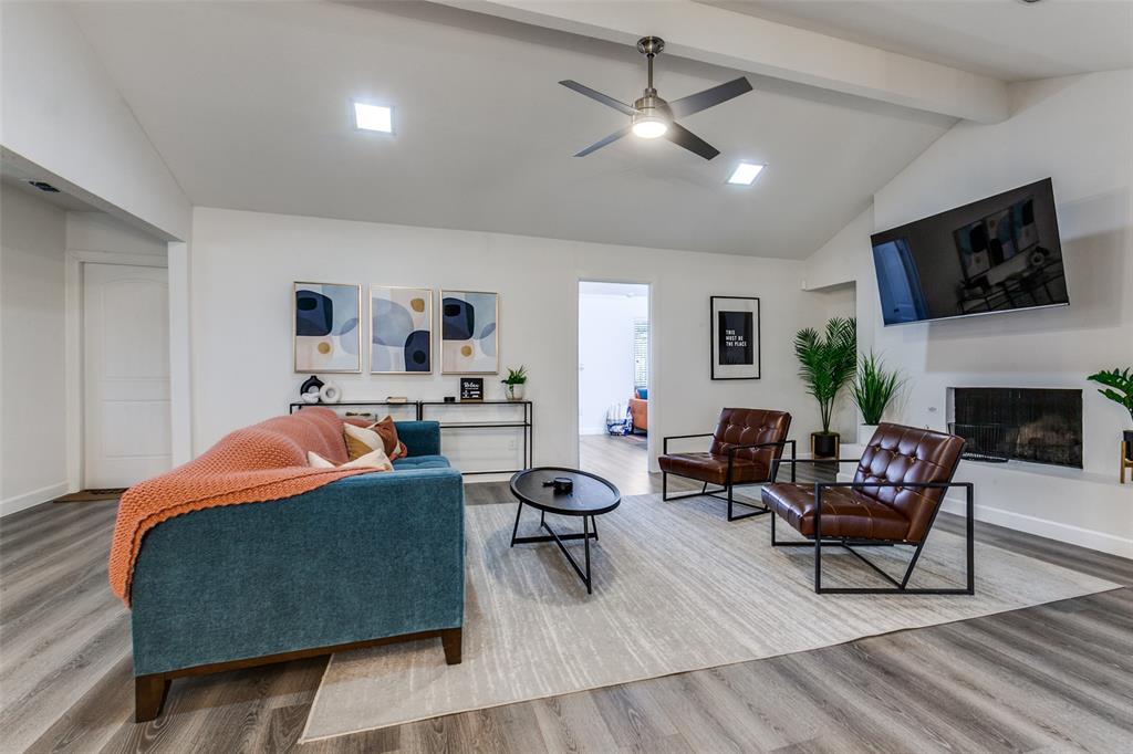 2901 Regal Road Plano, TX 75075 - Photo 3 of 23 a living room with furniture a flat screen tv and a fireplace