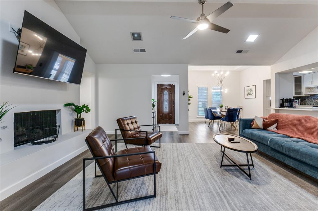 2901 Regal Road Plano, TX 75075 - Photo 4 of 23 a living room with furniture a flat screen tv and a fireplace