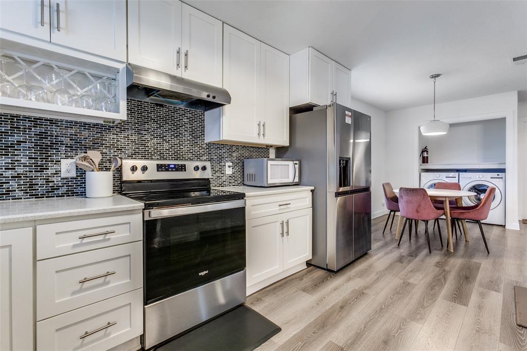 2901 Regal Road Plano, TX 75075 - Photo 10 of 23 a kitchen with stainless steel appliances granite countertop a stove a refrigerator and a cabinets