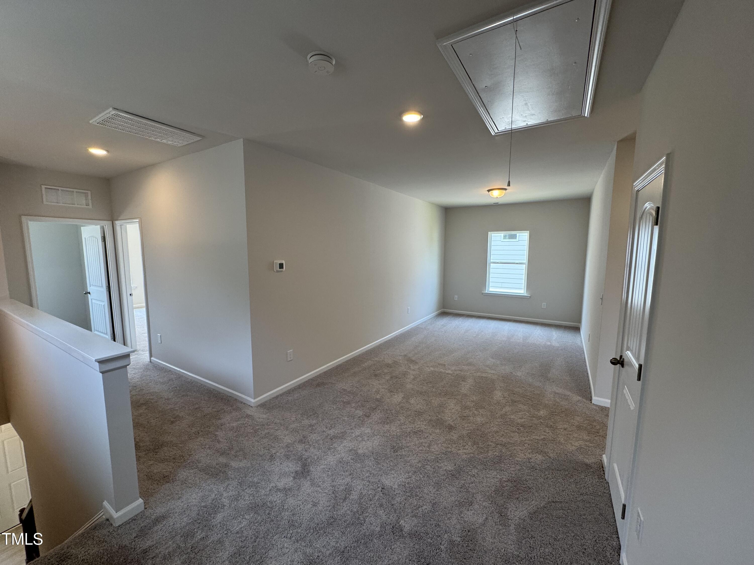 76 Commons Circle Clayton, NC 27520 - Photo 11 of 29 a view of entryway with window and wooden floor