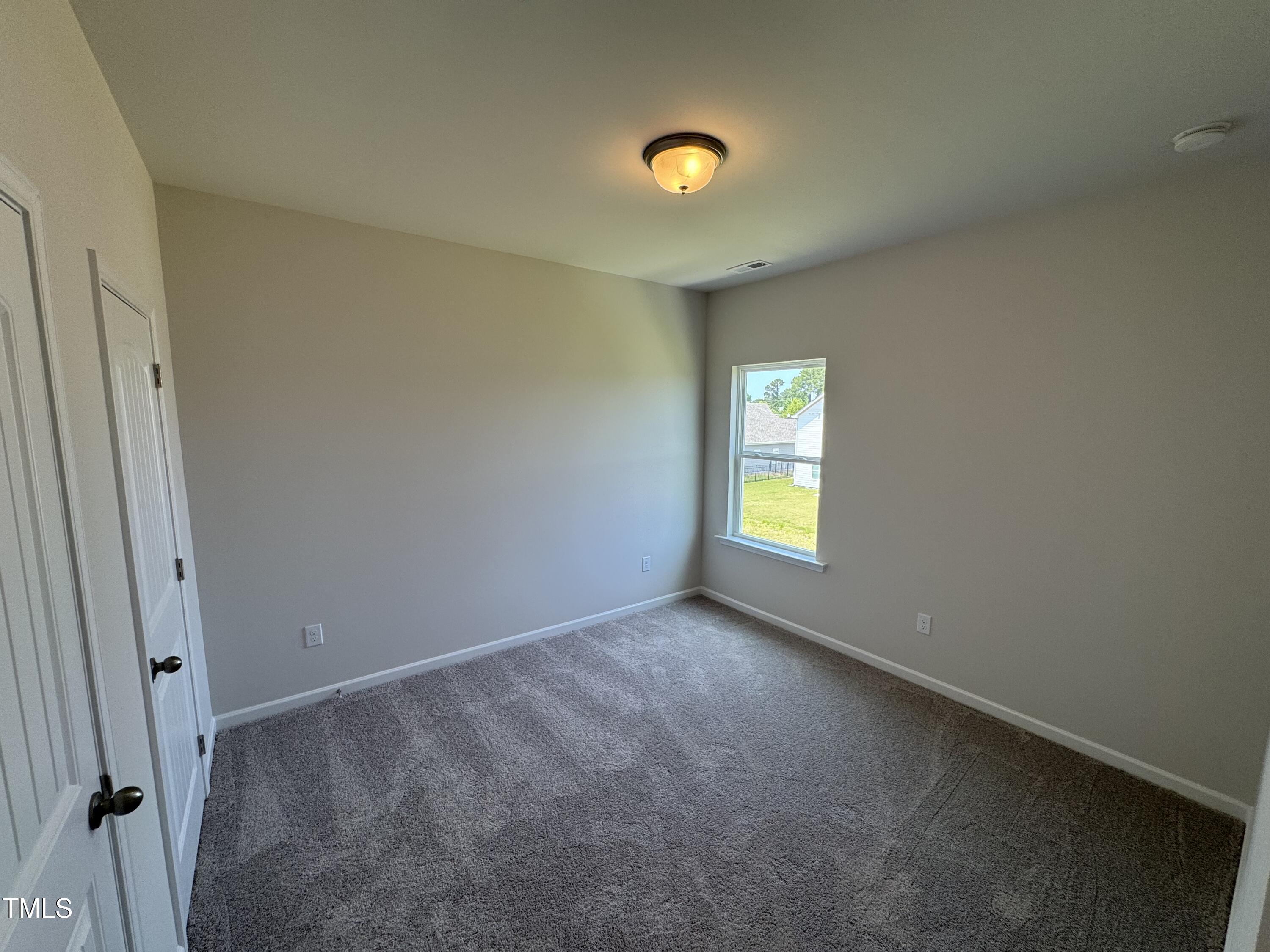 76 Commons Circle Clayton, NC 27520 - Photo 13 of 29 an empty room with windows