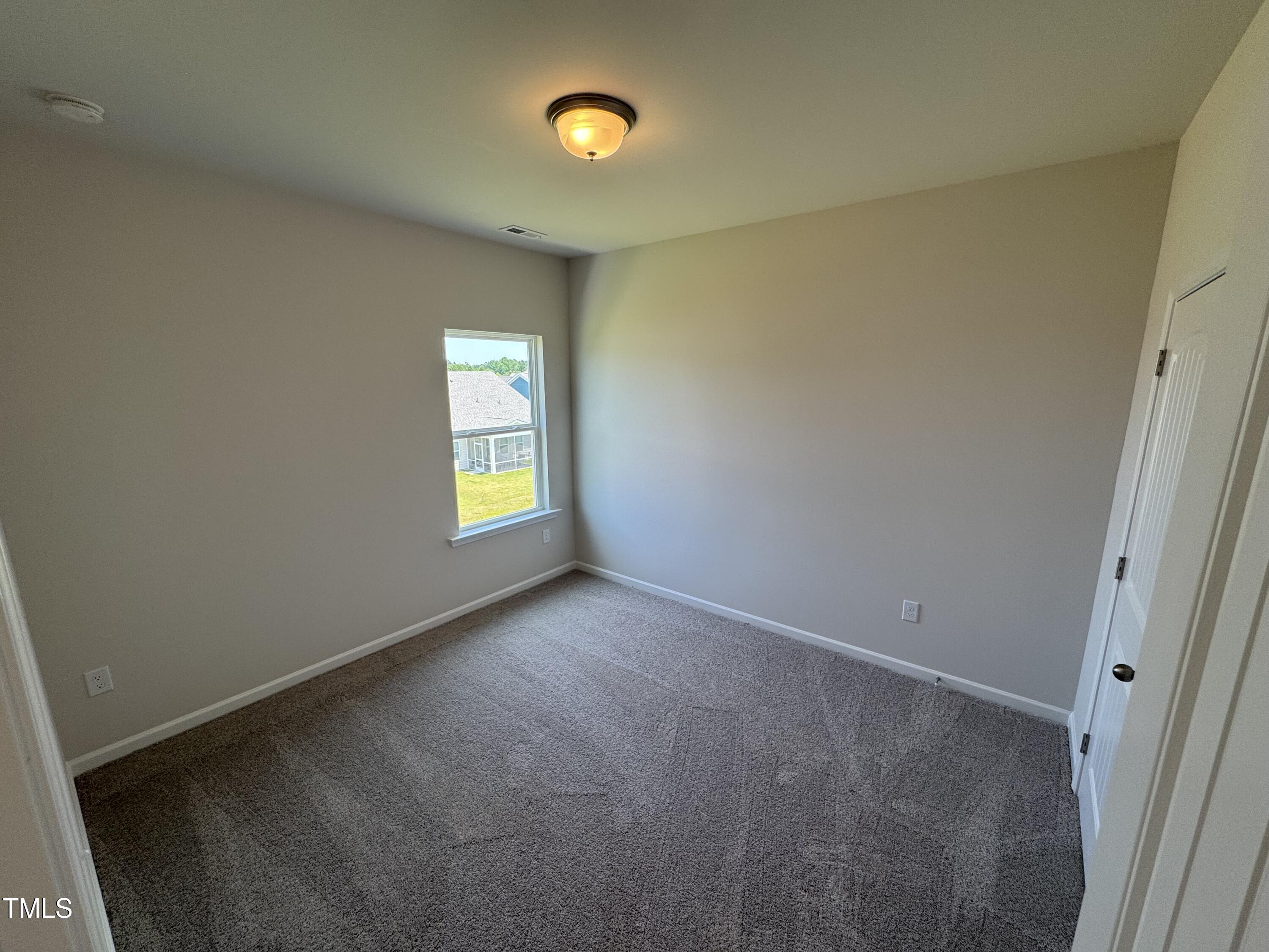 76 Commons Circle Clayton, NC 27520 - Photo 14 of 29 an empty room with windows