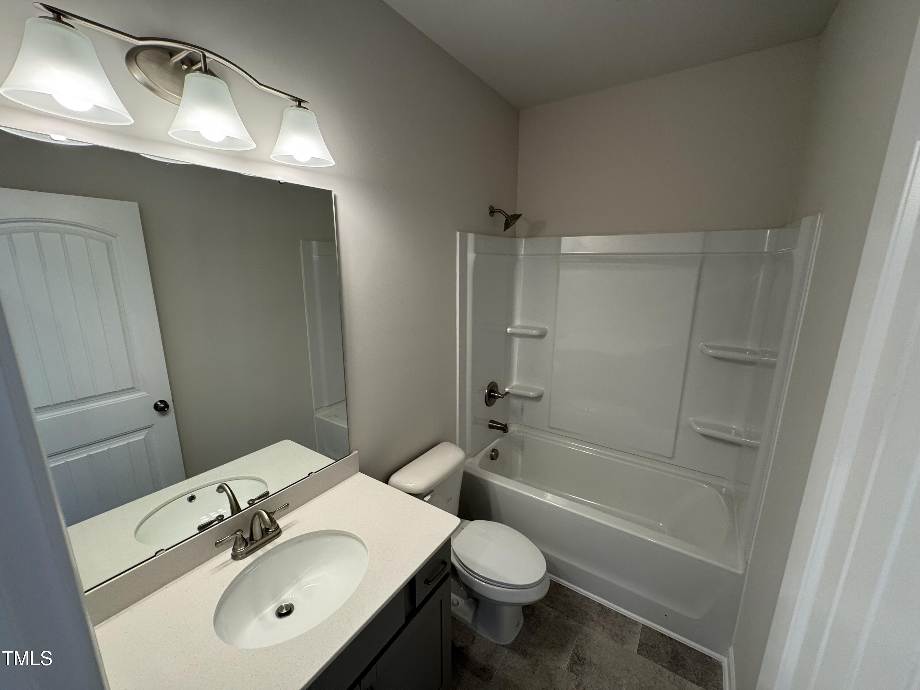 76 Commons Circle Clayton, NC 27520 - Photo 15 of 29 a bathroom with a sink toilet and shower