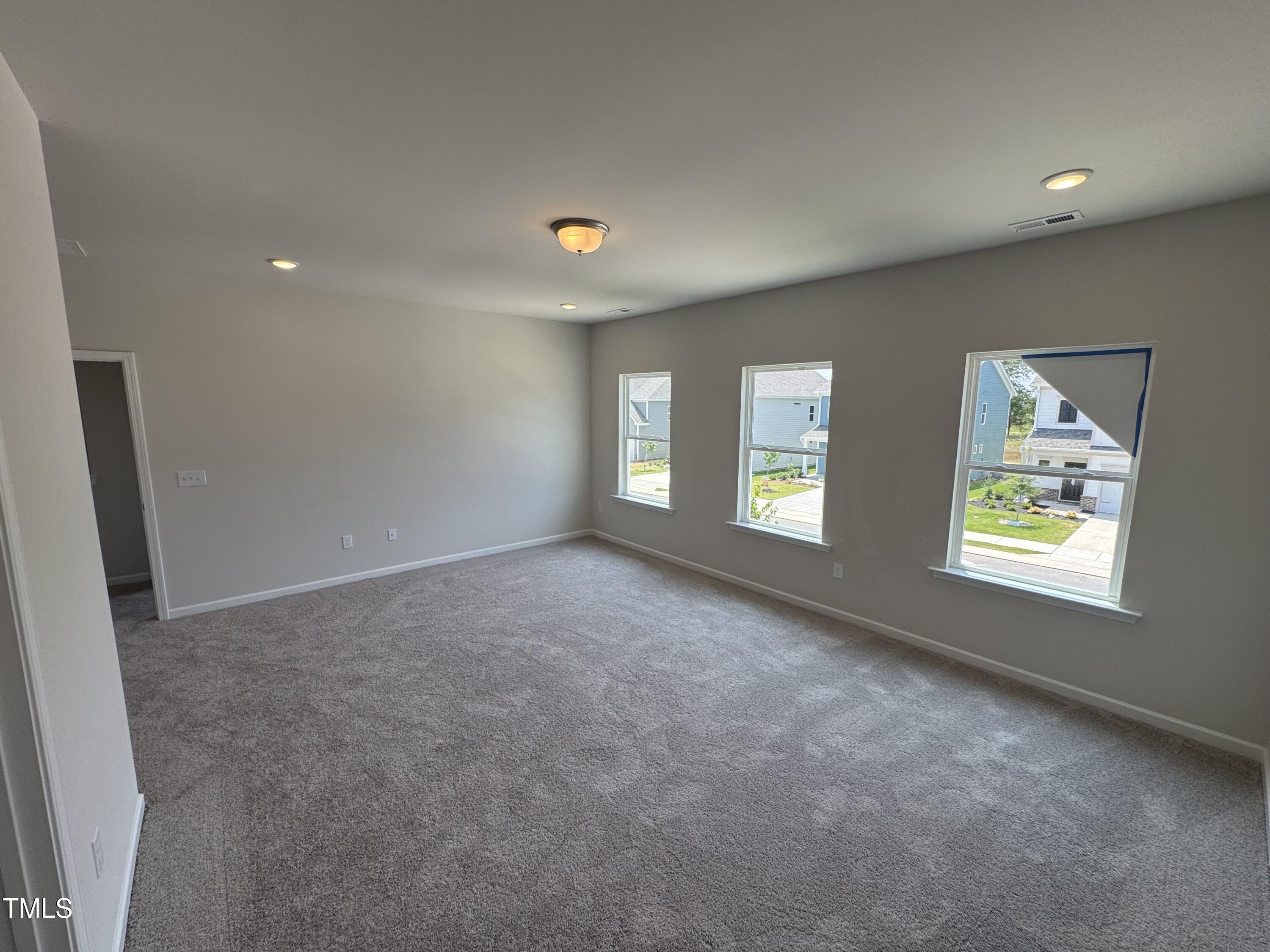 76 Commons Circle Clayton, NC 27520 - Photo 18 of 29 a view of an empty room with a window