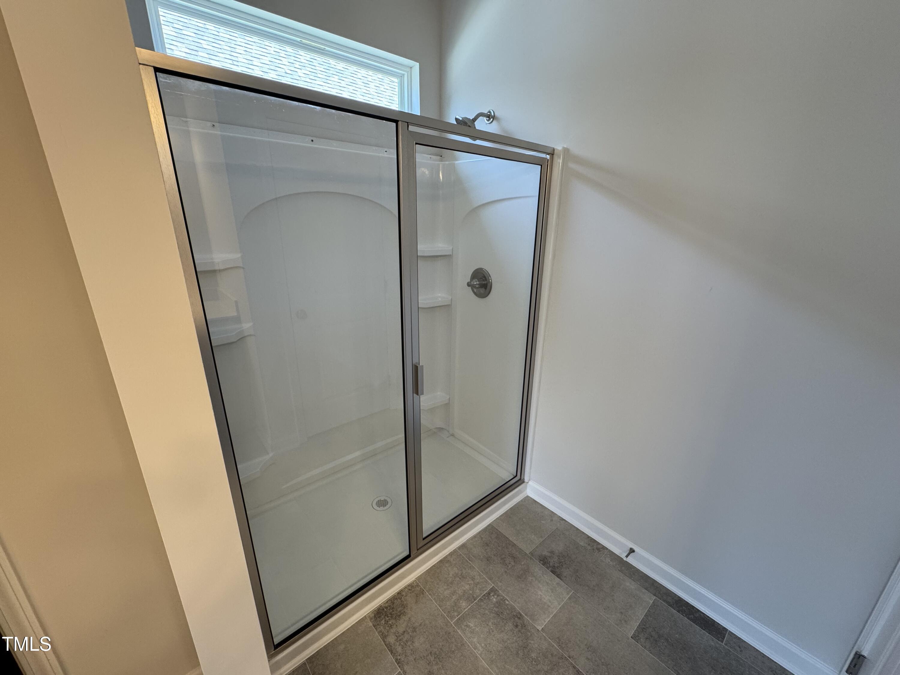 76 Commons Circle Clayton, NC 27520 - Photo 20 of 29 a bathroom with a glass door shower