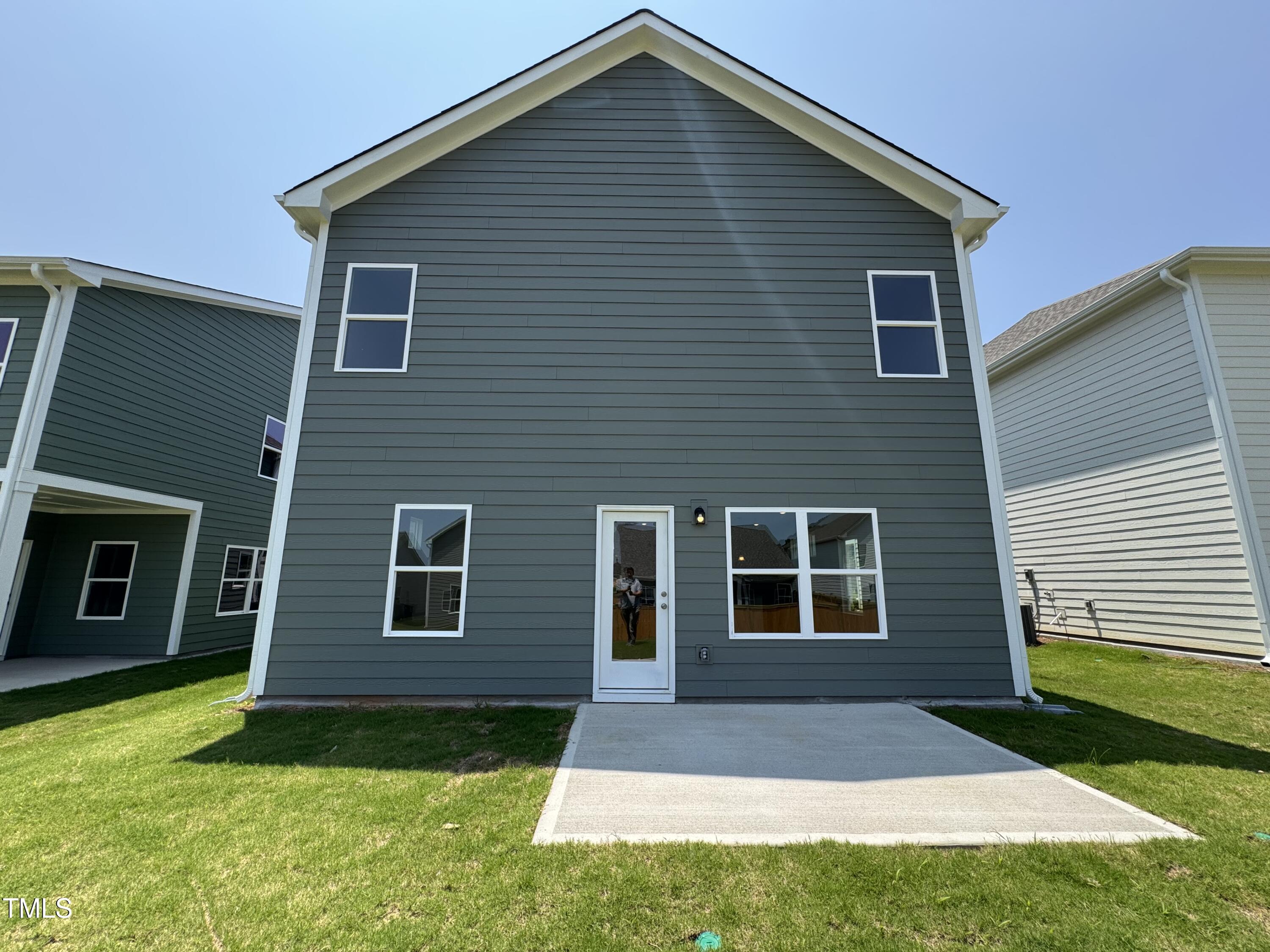 76 Commons Circle Clayton, NC 27520 - Photo 22 of 29 a front view of a house with a yard