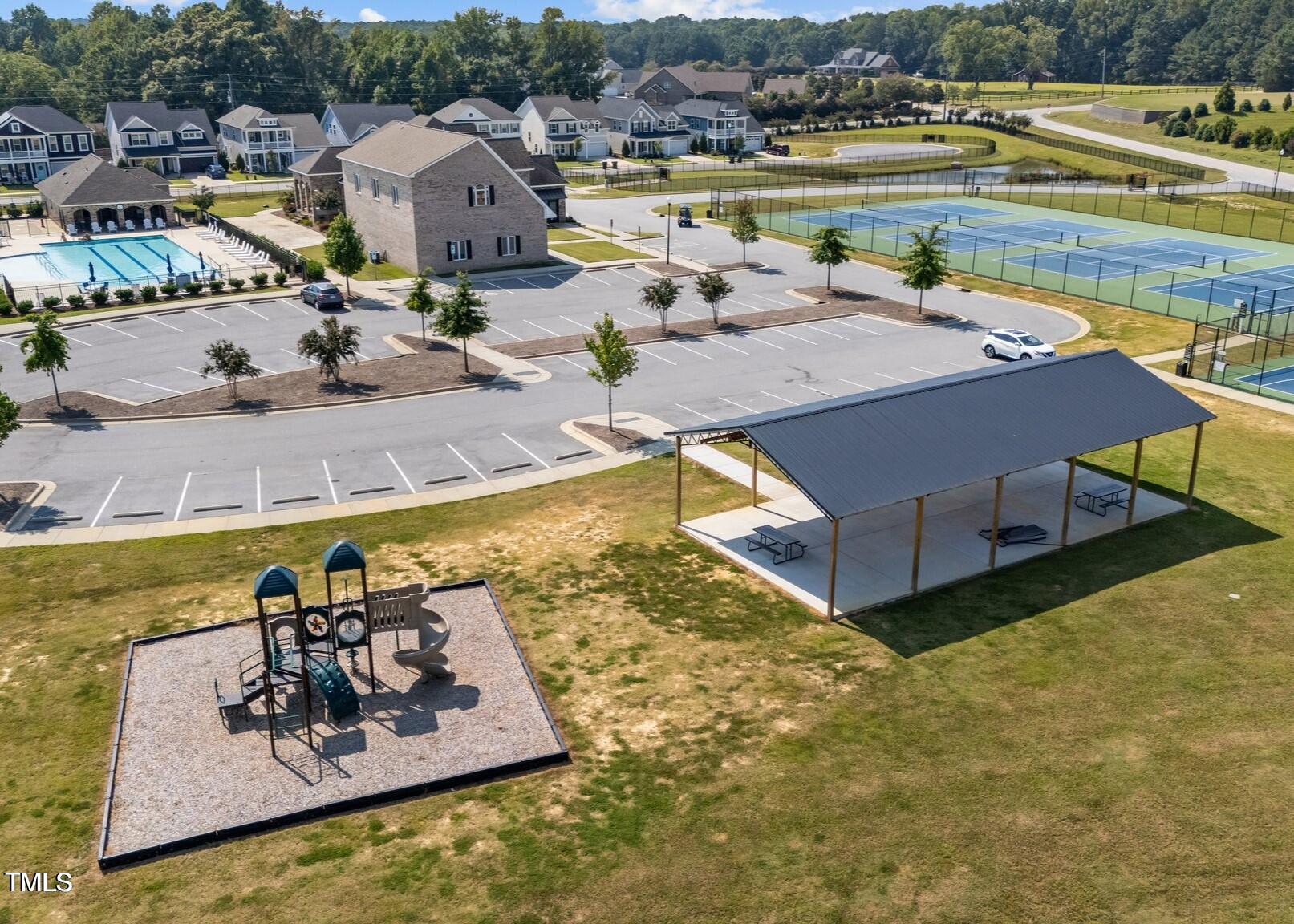 76 Commons Circle Clayton, NC 27520 - Photo 23 of 29 a view of a swimming pool with a lake view