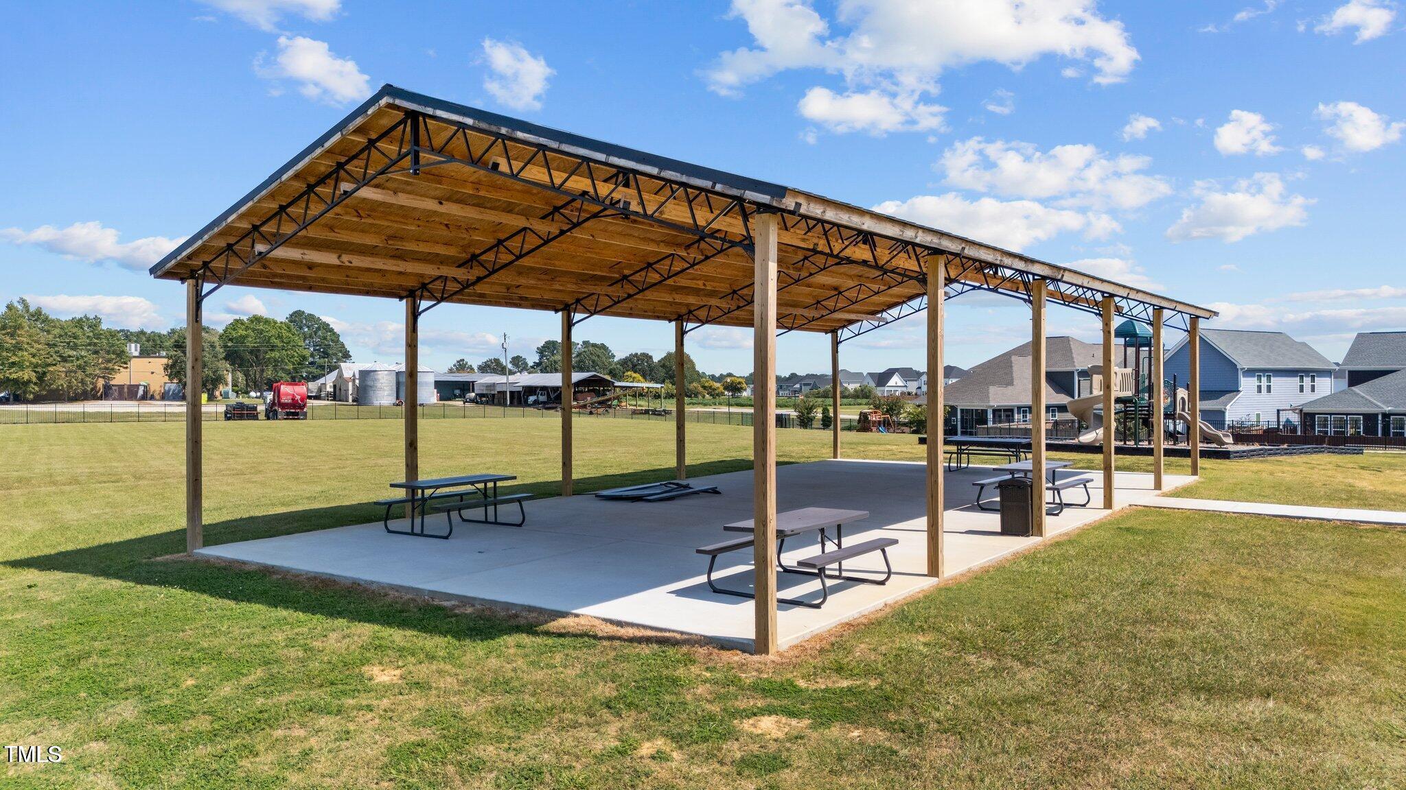 76 Commons Circle Clayton, NC 27520 - Photo 25 of 29 a view of a swimming pool with a bench and lawn chairs