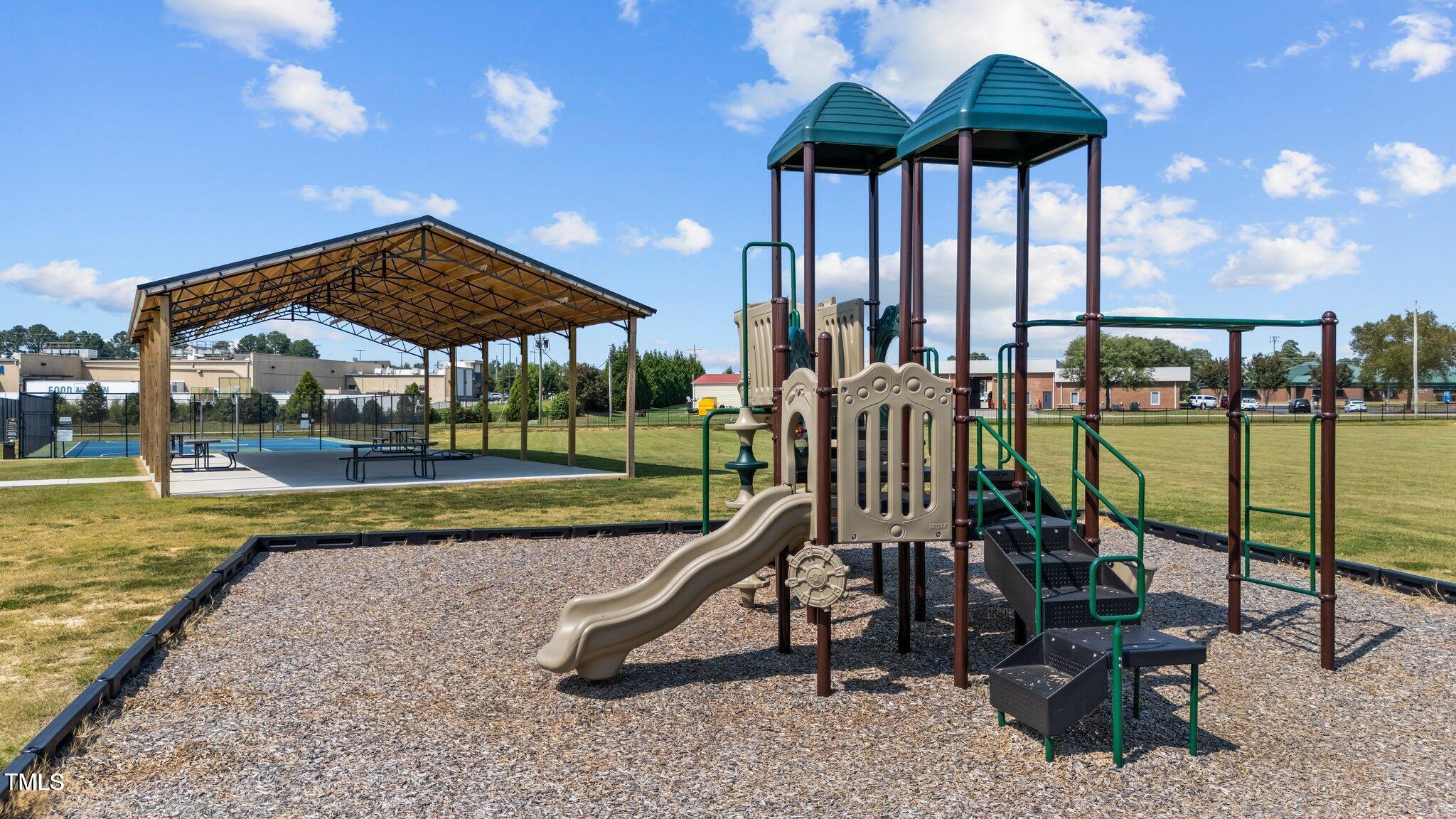 76 Commons Circle Clayton, NC 27520 - Photo 26 of 29 a view of a swimming pool with a patio and a yard