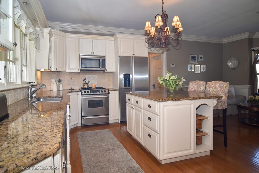 50 Cook Road Cumberland, RI 02864 - Photo 11 of 42 a kitchen with white cabinets and appliances