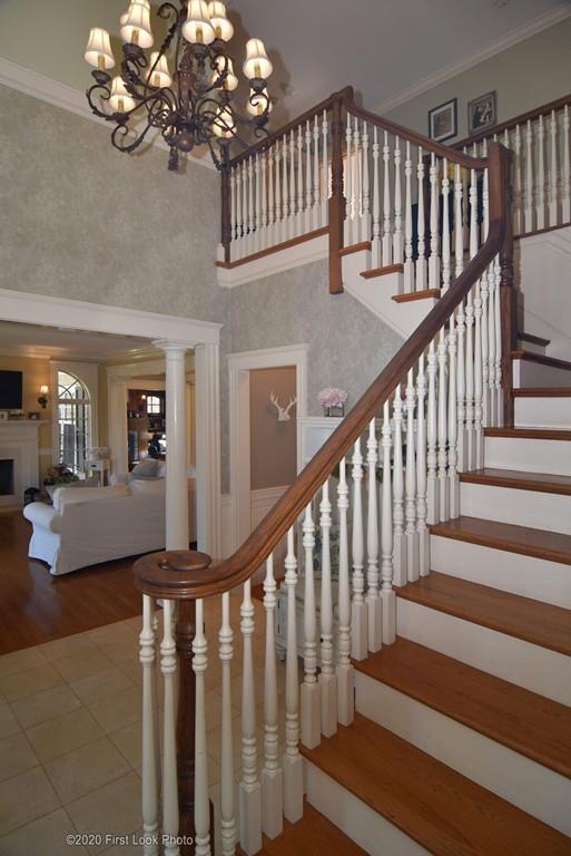 50 Cook Road Cumberland, RI 02864 - Photo 20 of 42 a view of staircase with wooden floor and a chandelier