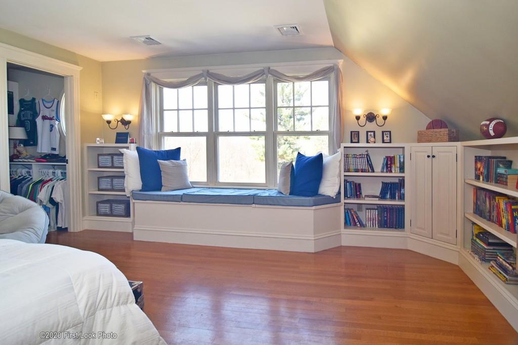50 Cook Road Cumberland, RI 02864 - Photo 26 of 42 a spacious bedroom with a large bed and a book shelf