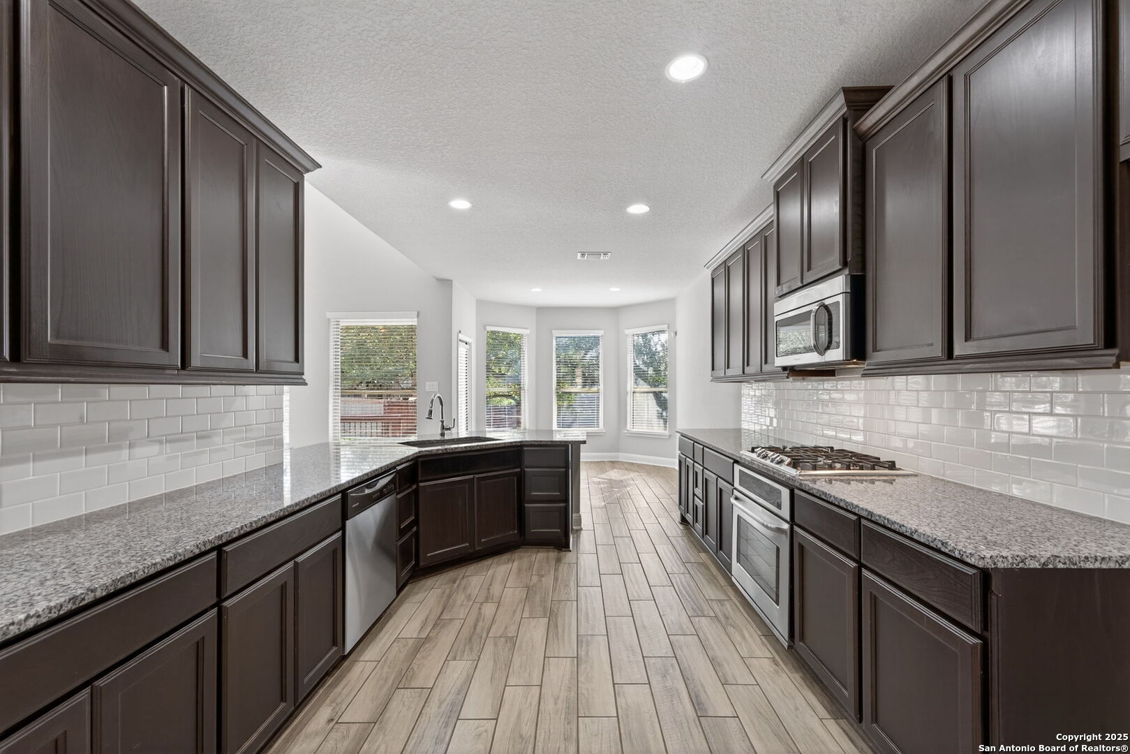 8326 Hydrangea Path Boerne, TX 78015 - Photo 11 of 39 a kitchen with stainless steel appliances granite countertop counter space a sink and cabinets
