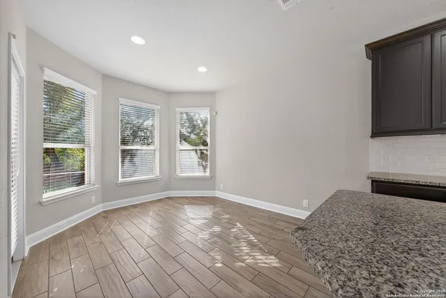 a view of a livingroom with wooden floor and a window