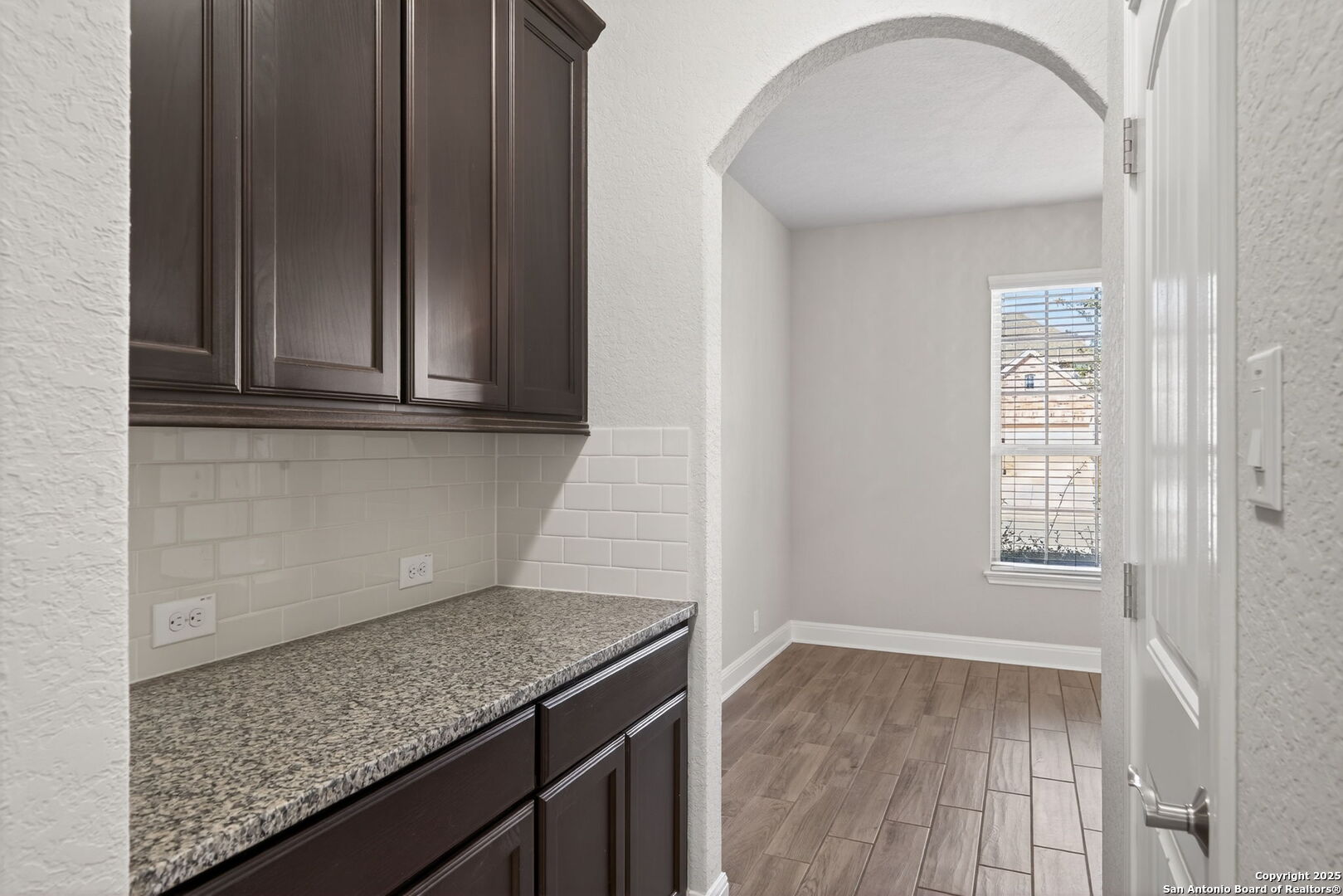 8326 Hydrangea Path Boerne, TX 78015 - Photo 14 of 39 a kitchen with granite countertop a sink and wooden cabinets